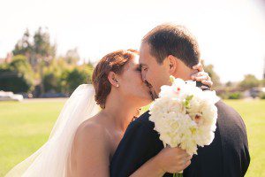 Kim_Matt_Bride_Groom_SantaBarbara_Kissing_White_Flowers